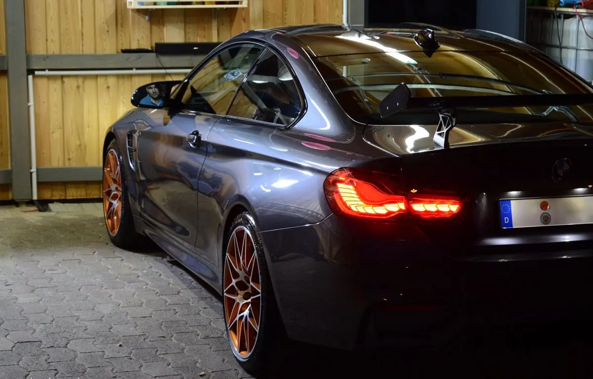 Finished BMW M4 GTS in the garage with tail lights on