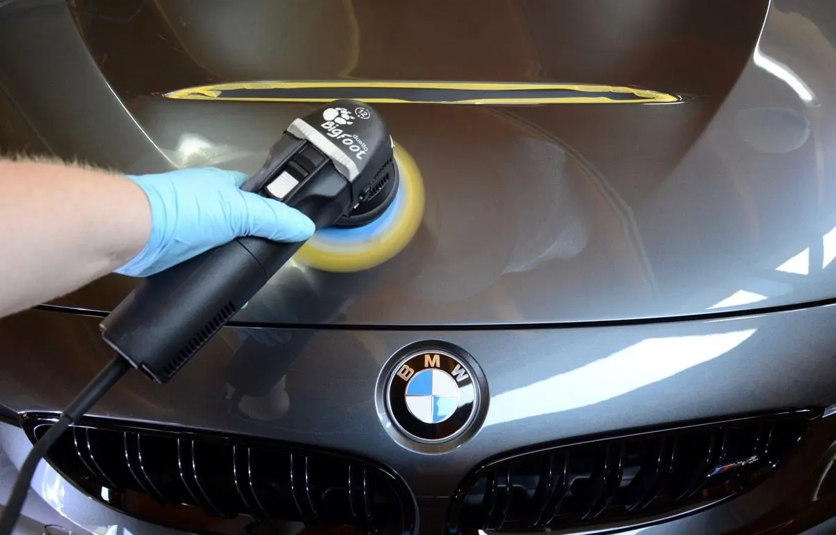 Machine polishing the bonnet of a BMW M4 GTS